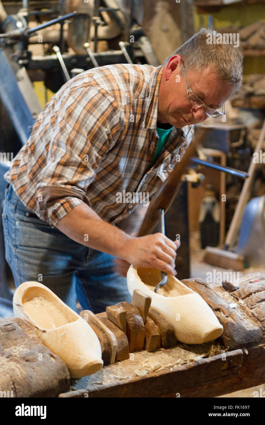 Wooden clog maker in Munster Valley Alsace France Stock Photo
