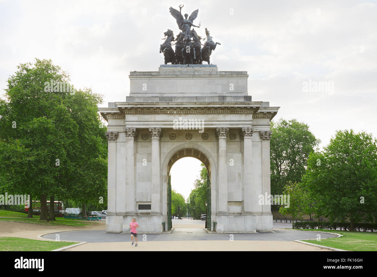 Wellington Arch or Constitution Arch is a triumphal arch located to the south of Hyde Park in London, man jogging in the morning Stock Photo