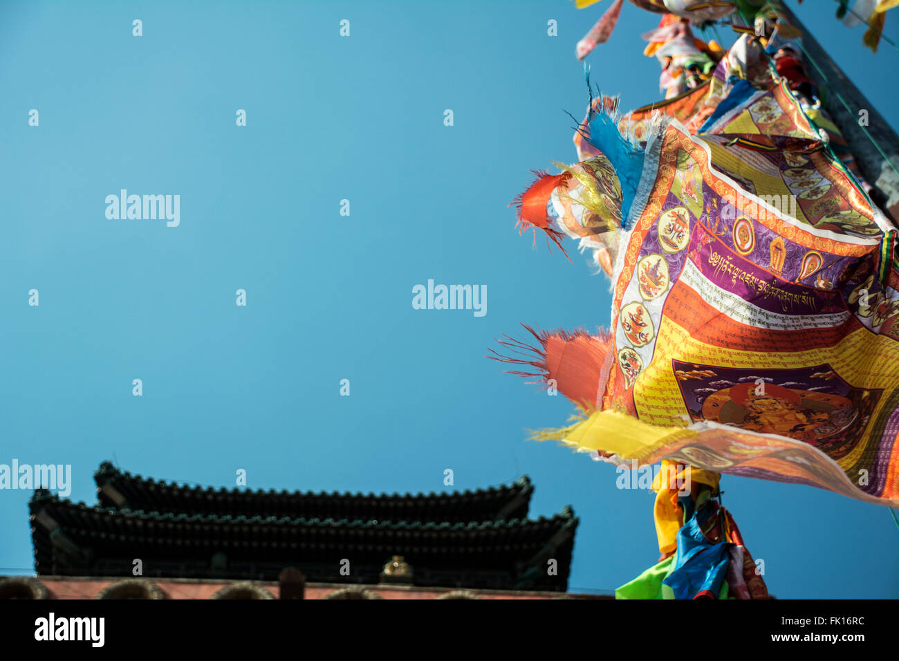 Buddhist texts on Tibetan flags before a China temple Stock Photo