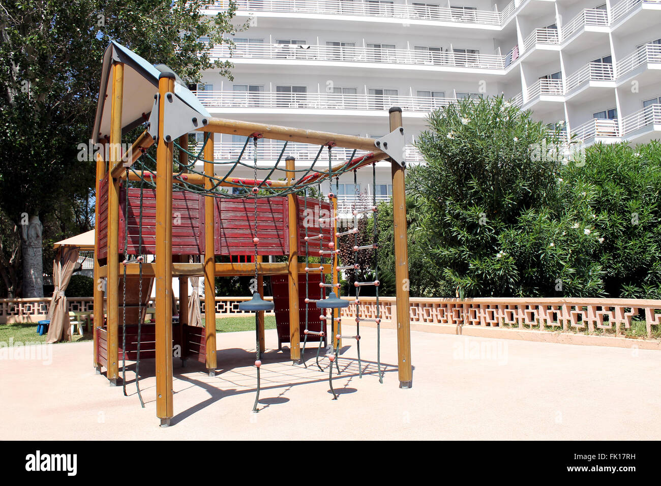 Childrens play park in the grounds of a modern hotel building. Stock Photo