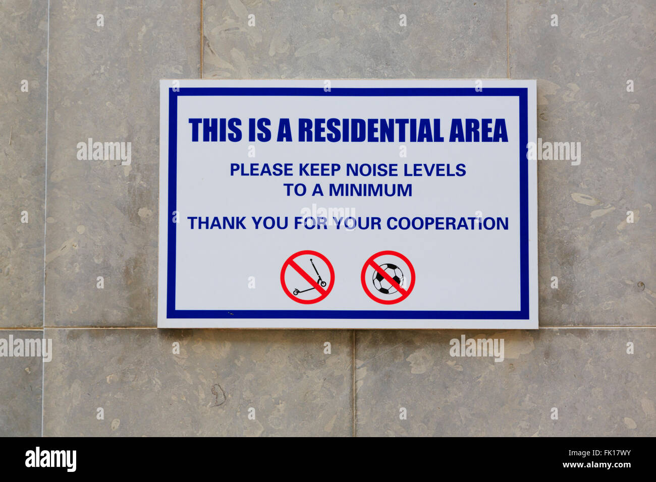 Sign on wall of residential area warning to keep noise and games to a minimum Stock Photo