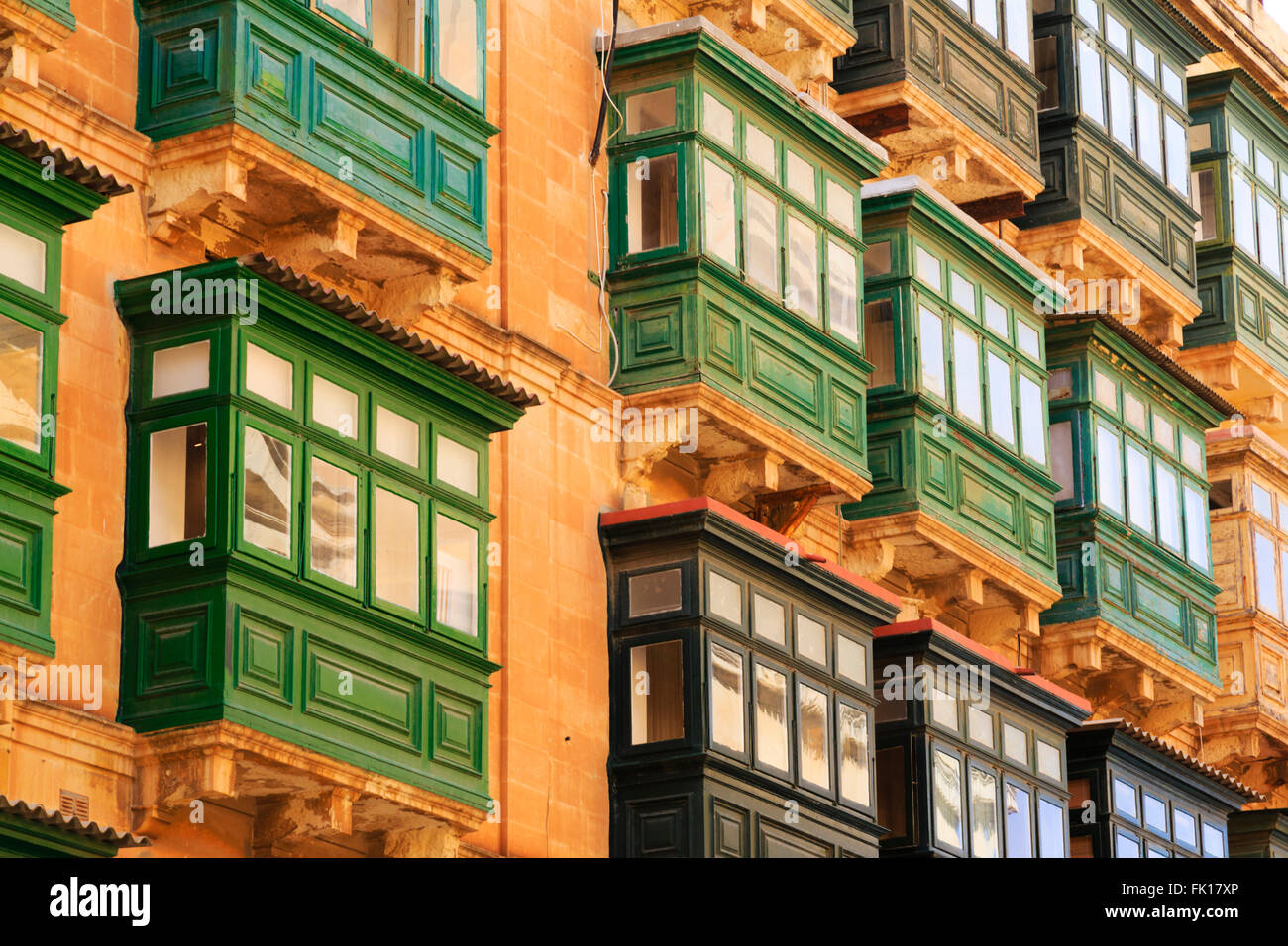 Traditional balconies in multi storey houses, Valletta, Malta Stock Photo