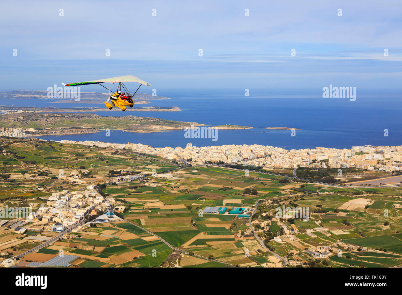 Aerial view of microlight flexwing over Bugibba, with St Pauls Islands