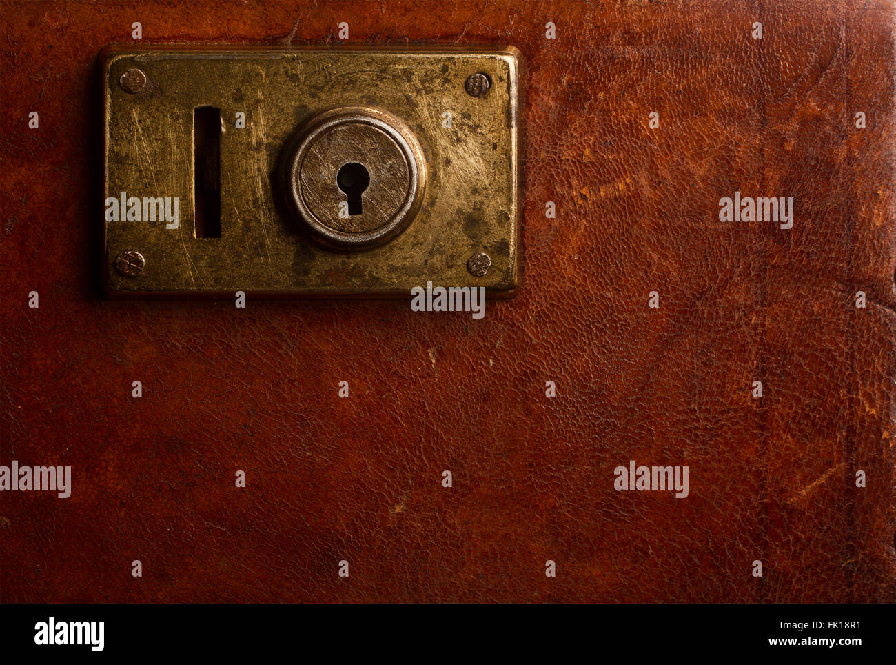 Horizontal close up of an old locking mechanism on a vintage suitcase made of brown leather Stock Photo