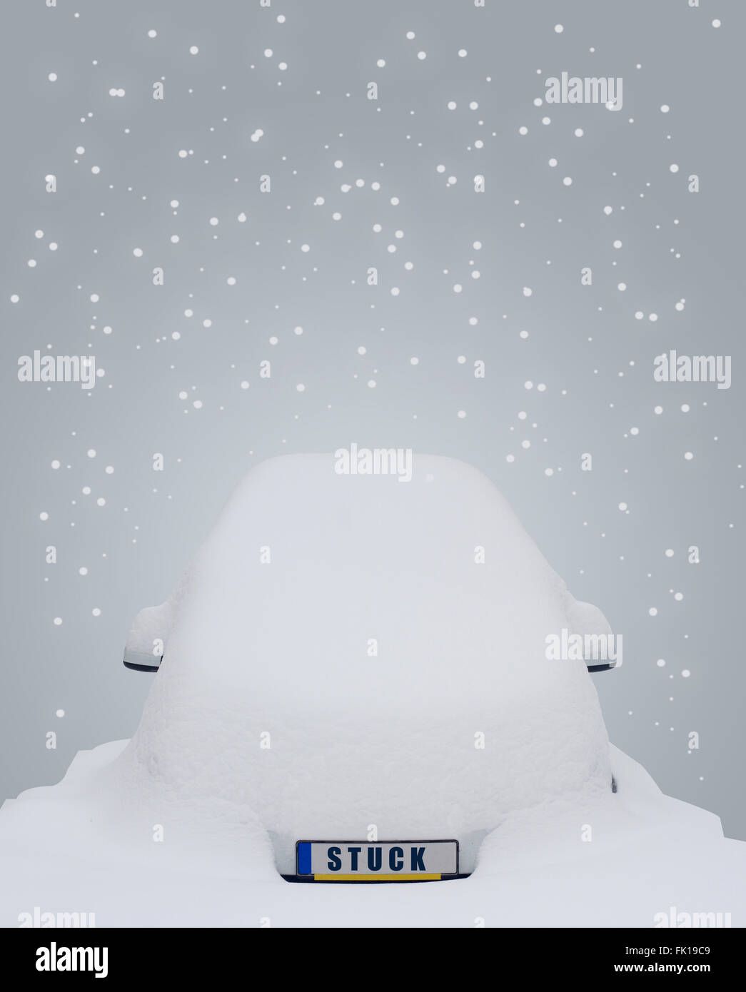 Car covered in snow with the word stuck writen on the license plate and