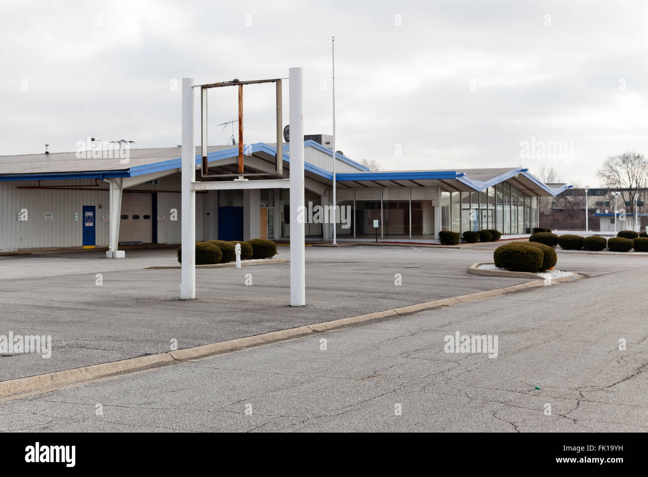 Car dealer out of business. Dealership signs have been removed and the building is closed, vacant and empty. Stock Photo