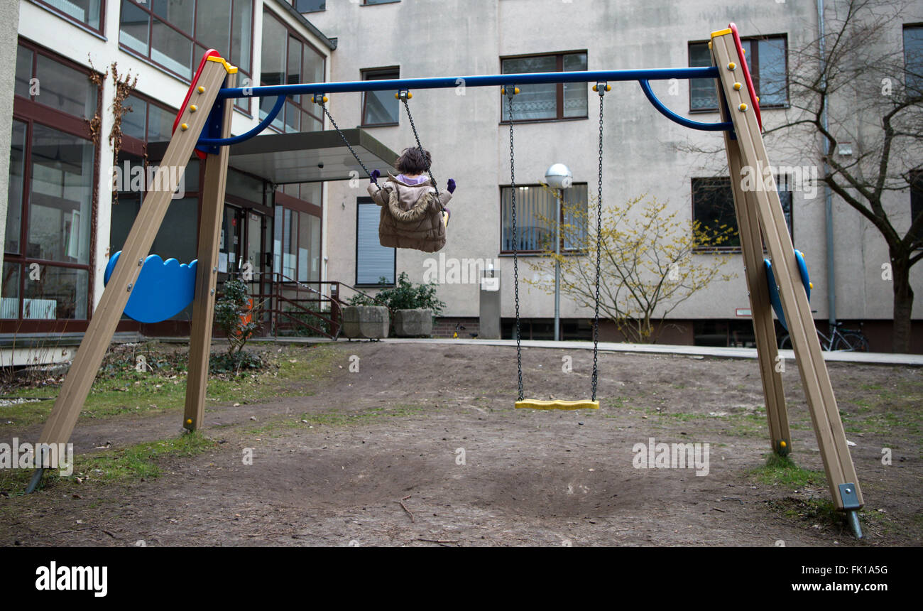 Berlin, Germany. 03rd Mar, 2016. A refugee child swings in front of a residential home for female refugees and refugee families in Berlin, Germany, 03 March 2016. Photo: BERND VON JUTRZCENKA/dpa/Alamy Live News Stock Photo