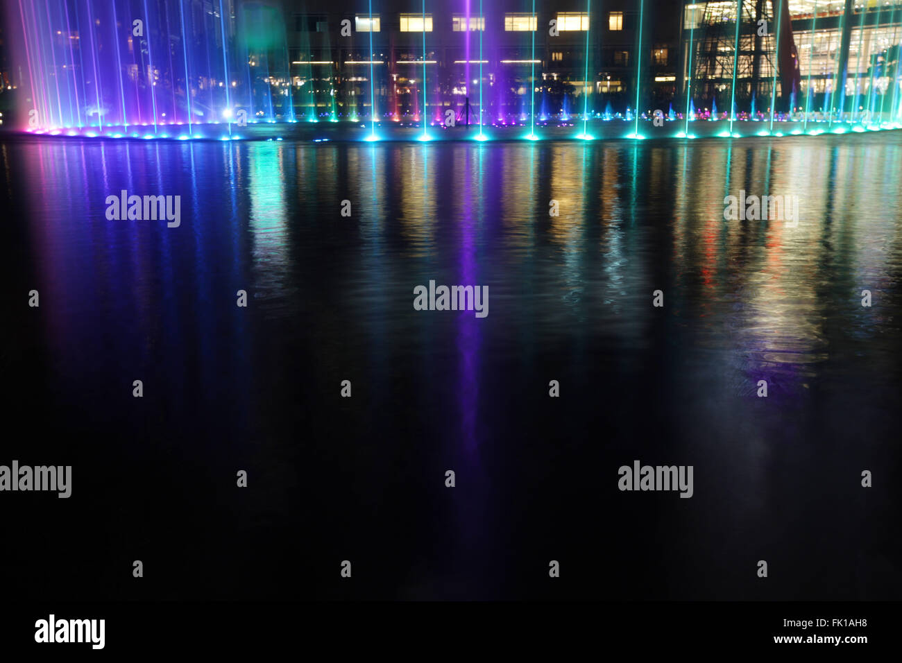 Illuminated fountain at night in modern city skyline, Kuala Lumpur ...