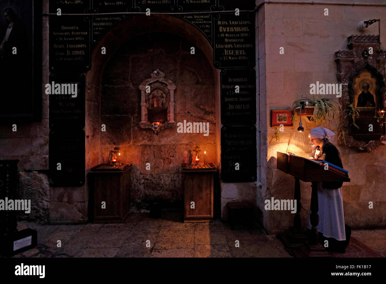 A Russian Orthodox Nun Praying Inside The Church Of Saint Alexander 