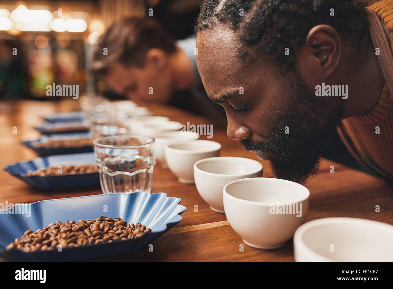 Coffee tasting with baristas smelling the aroma of many cups Stock Photo