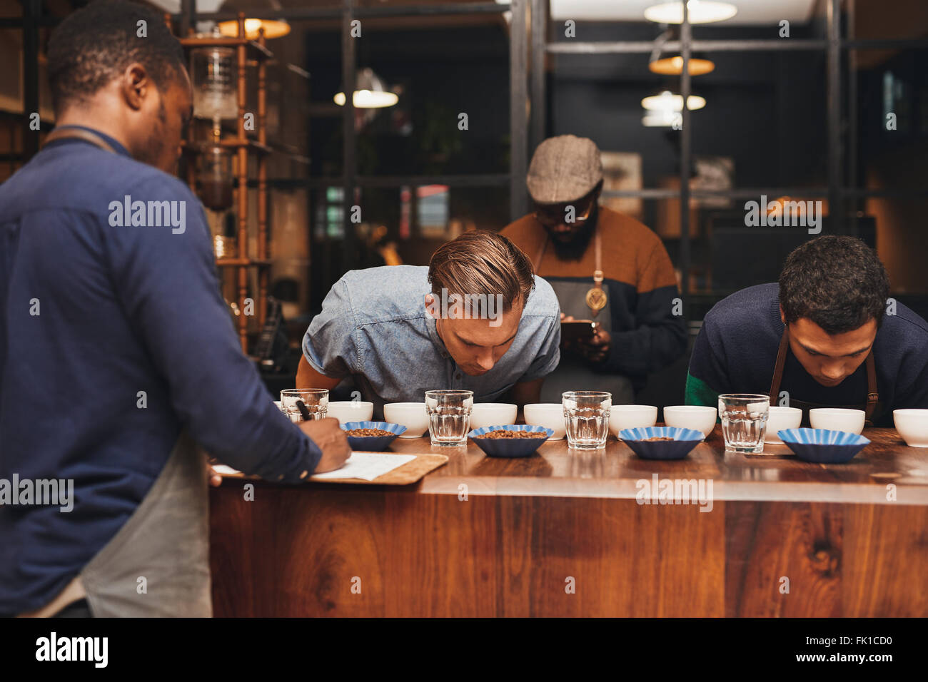 Barista training with rows of different coffees in roastery Stock Photo