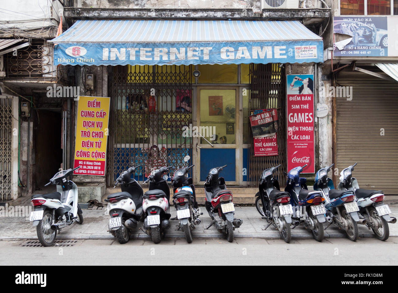 Exterior of an internet café in Hanoi Vietnam, early in the morning. People inside must have been there all night. Stock Photo