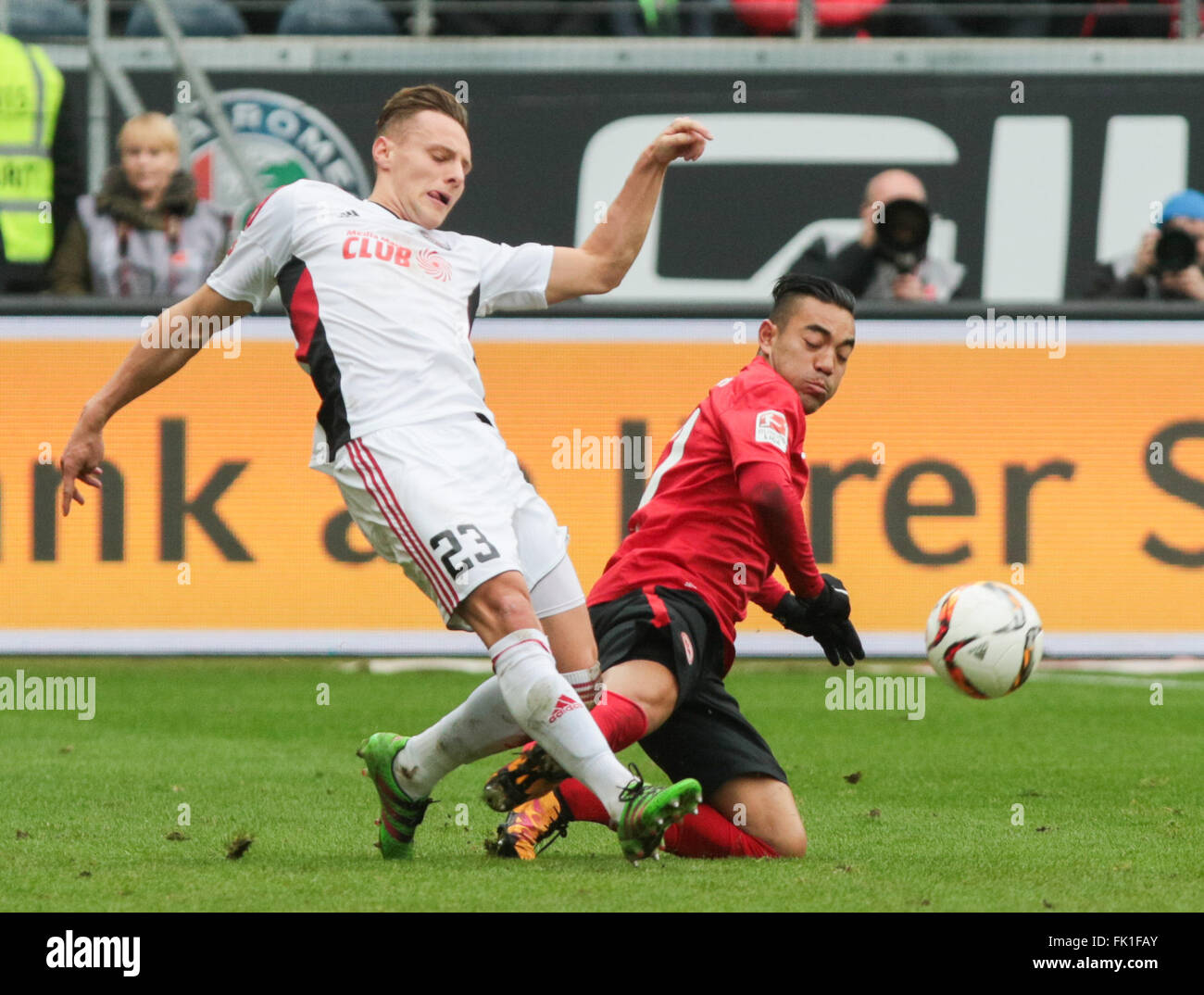 Ingolstadt's Robert Bauer (L) and Frankfurt's Marco Fabian vie for the ball with Ingolstadt's goalkeeper Ramazan Ozcan in the background during the German Bundesliga soccer match between Eintracht Frankfurt and FC Ingolstadt at the Commerzbank-Arena, Germany, 05 March 2016. Photo: FRANK RUMPENHORST/dpa (EMBARGO CONDITIONS - ATTENTION: Due to the accreditation guidelines, the DFL only permits the publication and utilisation of up to 15 pictures per match on the internet and in online media during the match.) Stock Photo