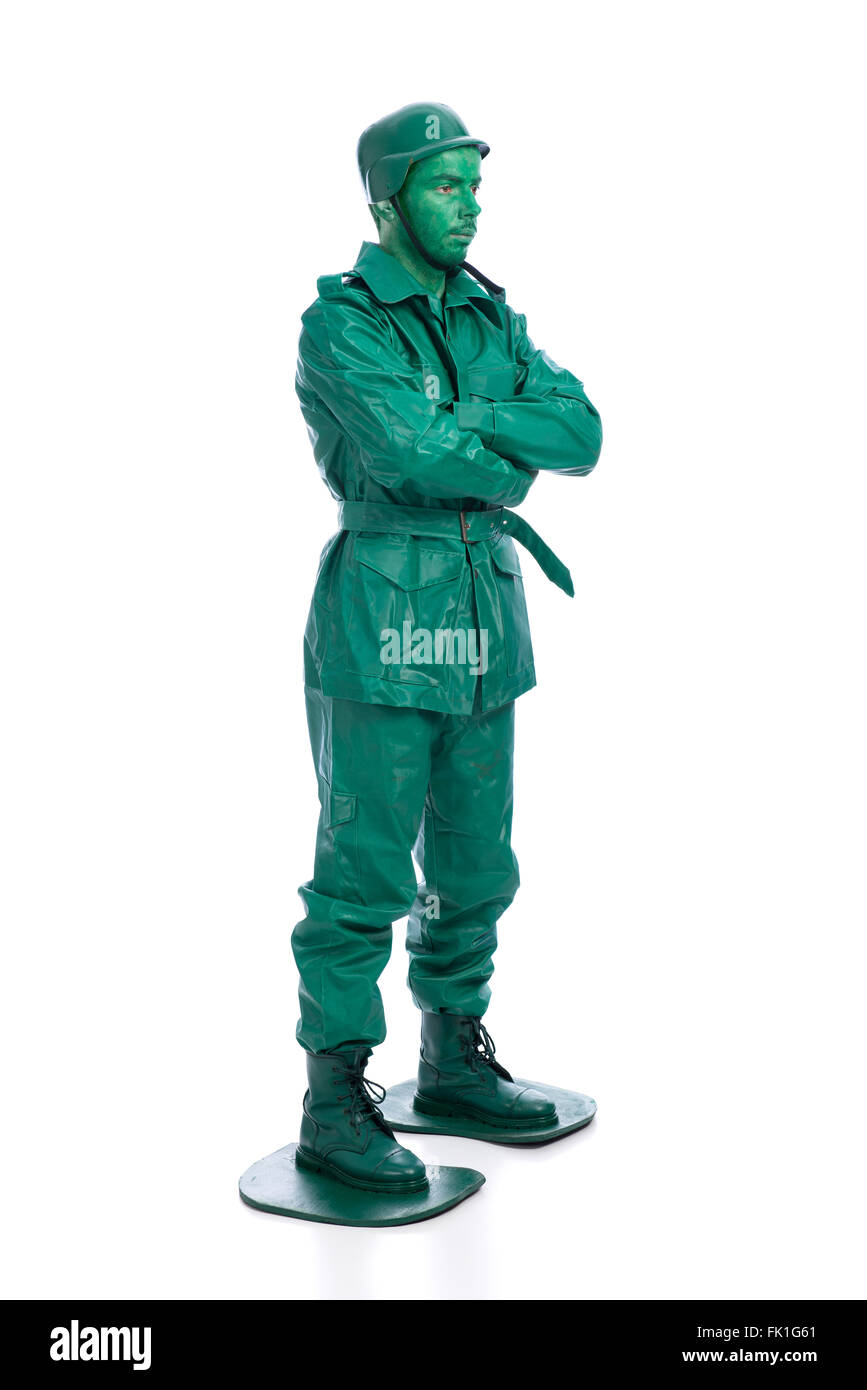 Man on a green toy soldier costume with arms crossed isolated on white  background Stock Photo - Alamy