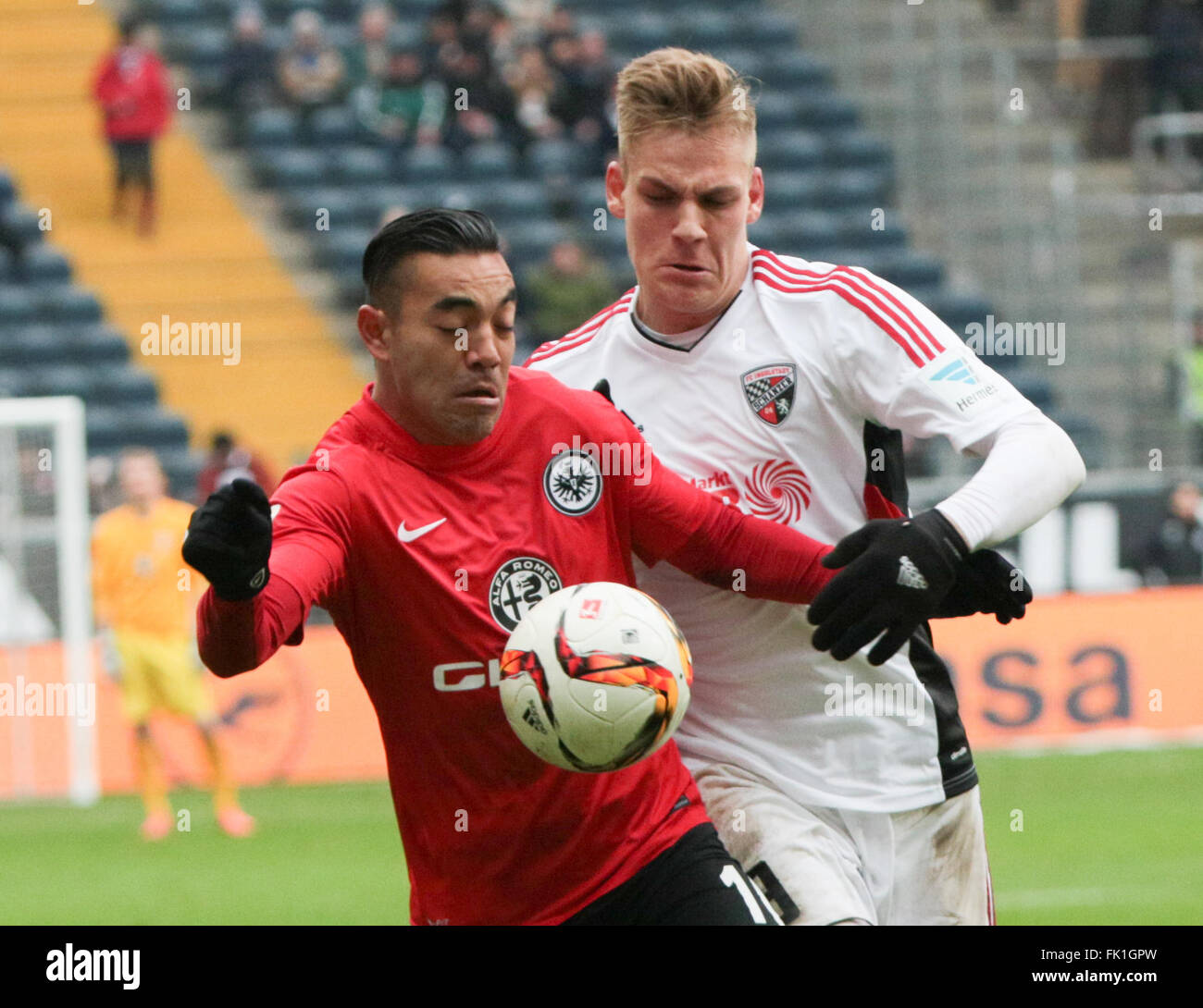 Frankfut's Marco Fabian (L) and Ingolstadt's Max Christiansen vie for the ball during the German Bundesliga soccer match between Eintracht Frankfurt and FC Ingolstadt at the Commerzbank-Arena, Germany, 05 March 2016. Photo: FRANK RUMPENHORST/dpa (EMBARGO CONDITIONS - ATTENTION: Due to the accreditation guidelines, the DFL only permits the publication and utilisation of up to 15 pictures per match on the internet and in online media during the match.) Stock Photo