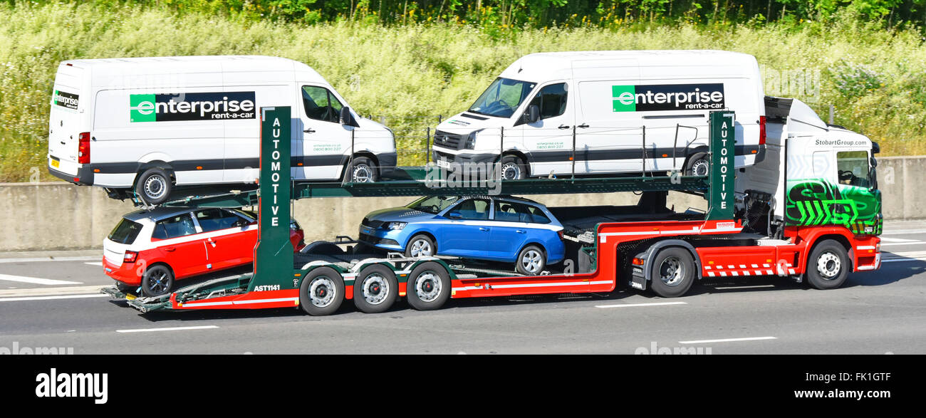 Car transporter articulated trailer behind Eddie Stobart hgv lorry truck mixed load including Enterprise vans driving along English UK motorway Stock Photo