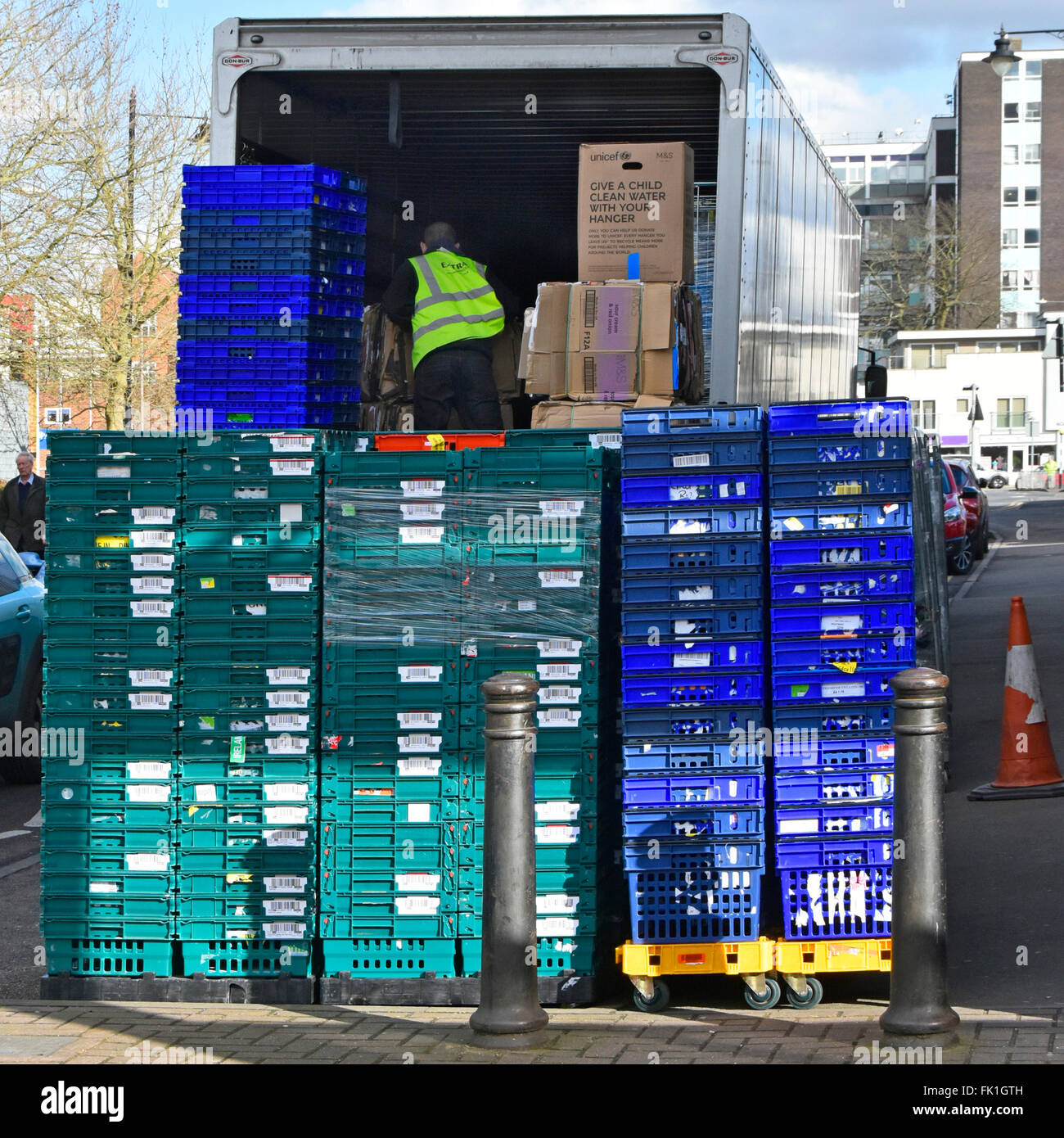 Supply chain completed articulated M&S lorry with driver unloading new delivery of merchandise to rear of high street store Brentwood Essex England UK Stock Photo