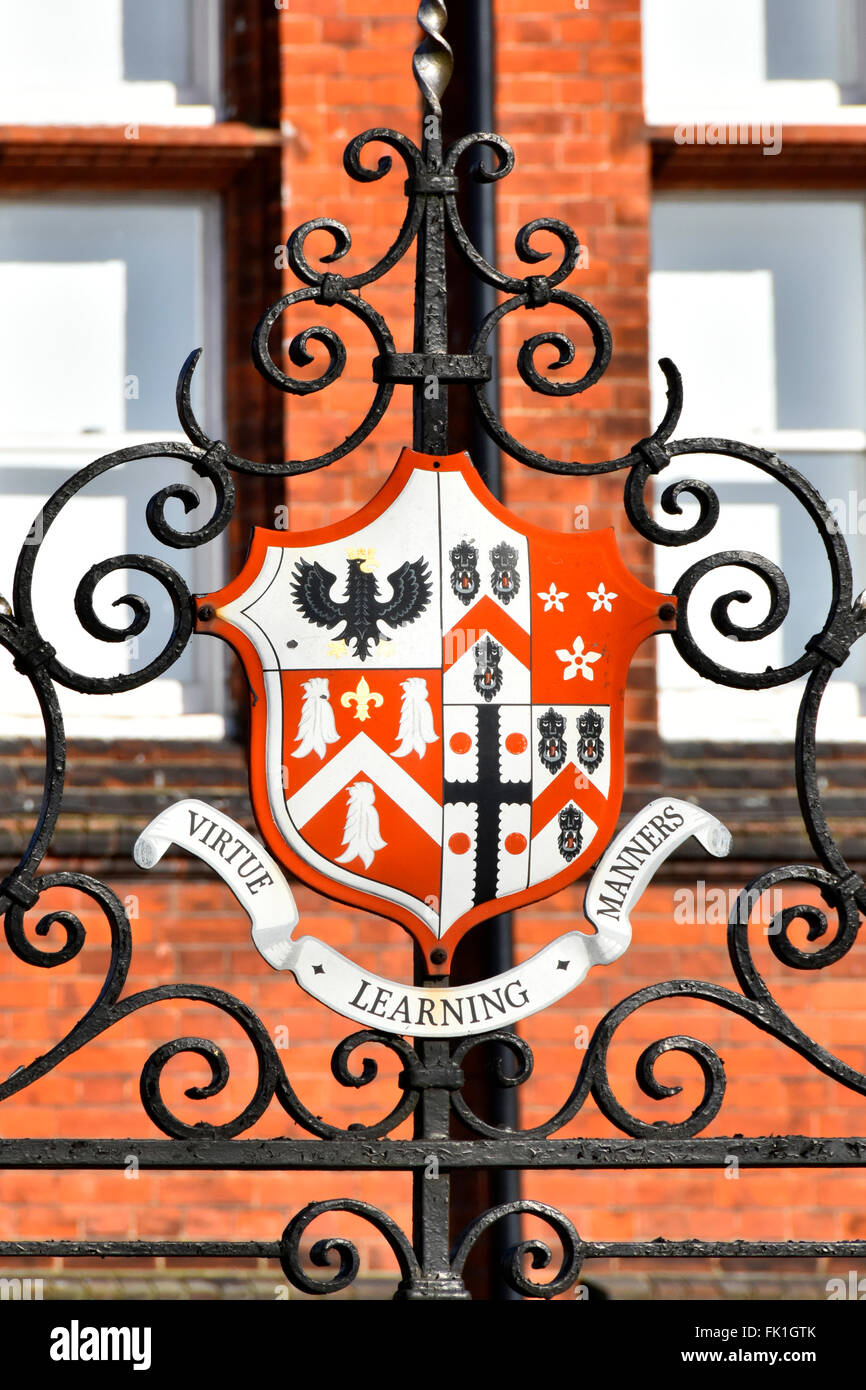 Brentwood School close up of coat of arms on school gates virtue Learning Manners motto on private school gate Essex England UK Stock Photo
