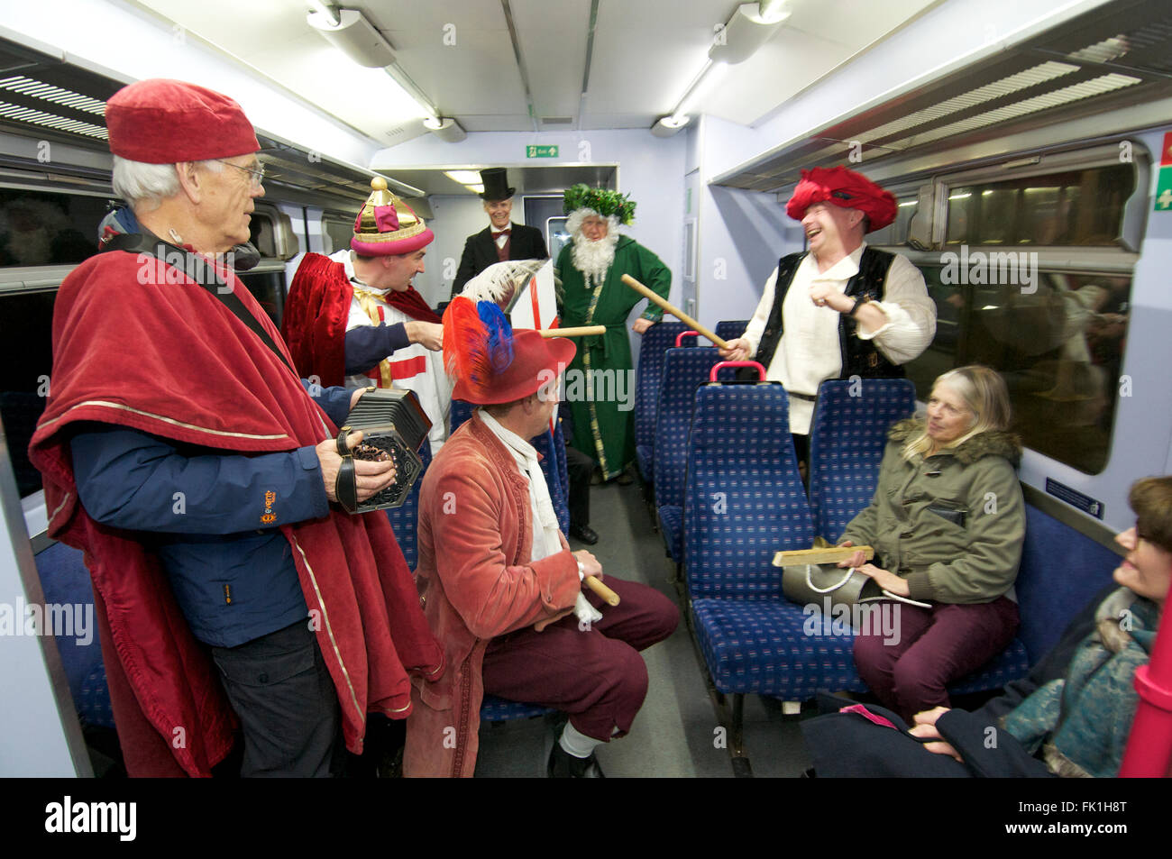 Lympstone Mummers perform on a train, Devon UK Stock Photo