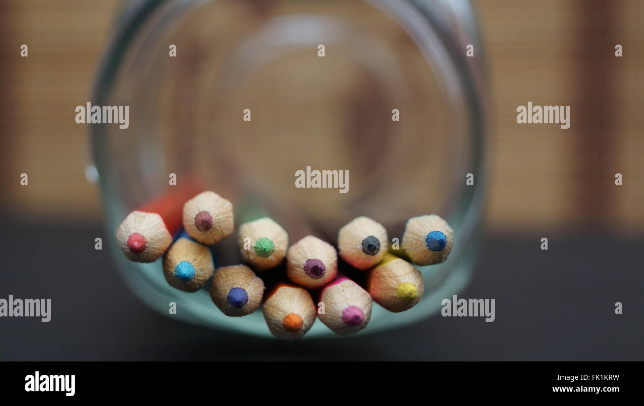 Coloured pencils lying down on the side of a glass jar Stock Photo Alamy