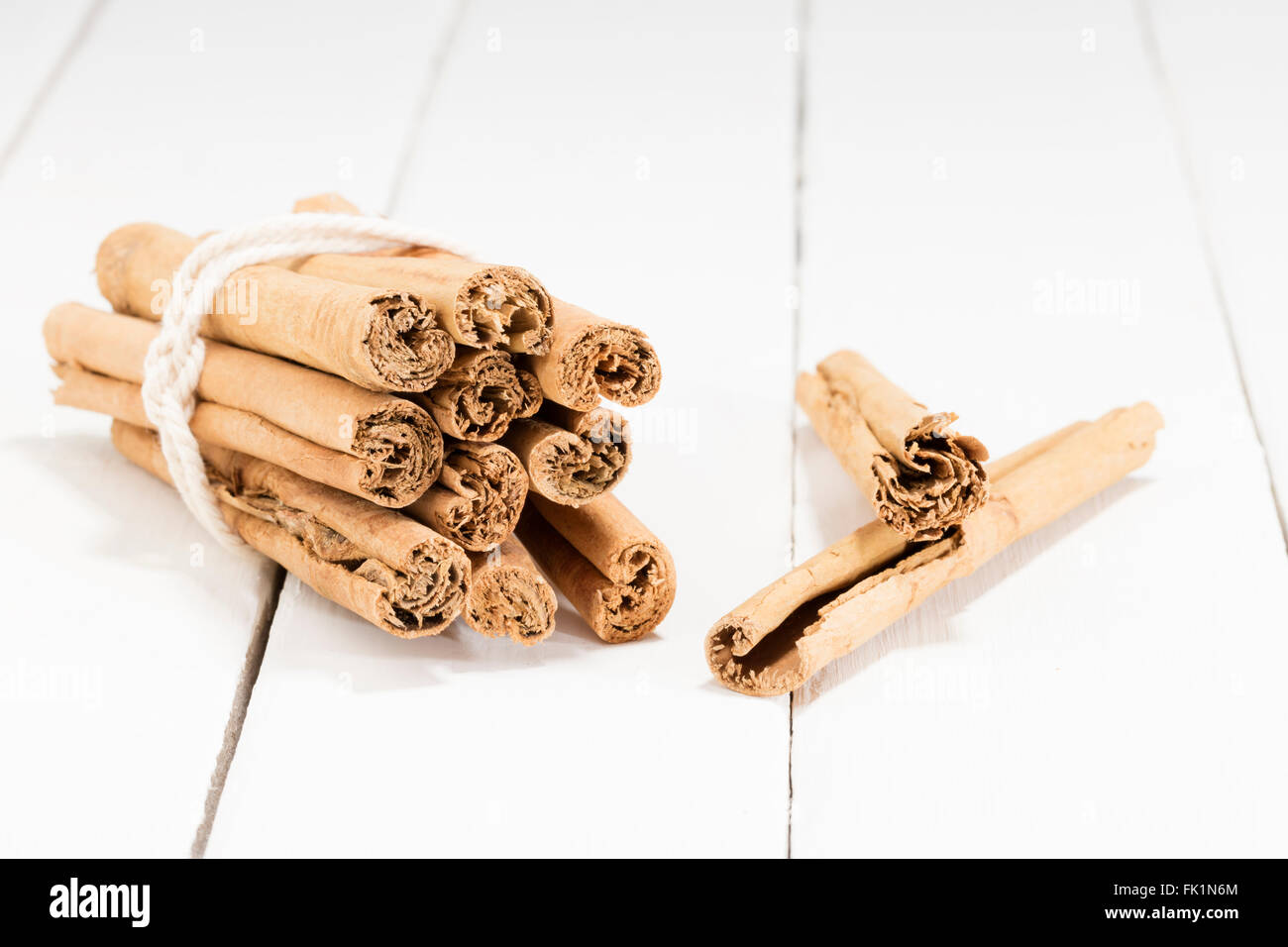 cinnamon sticks on a white kitchen table Stock Photo