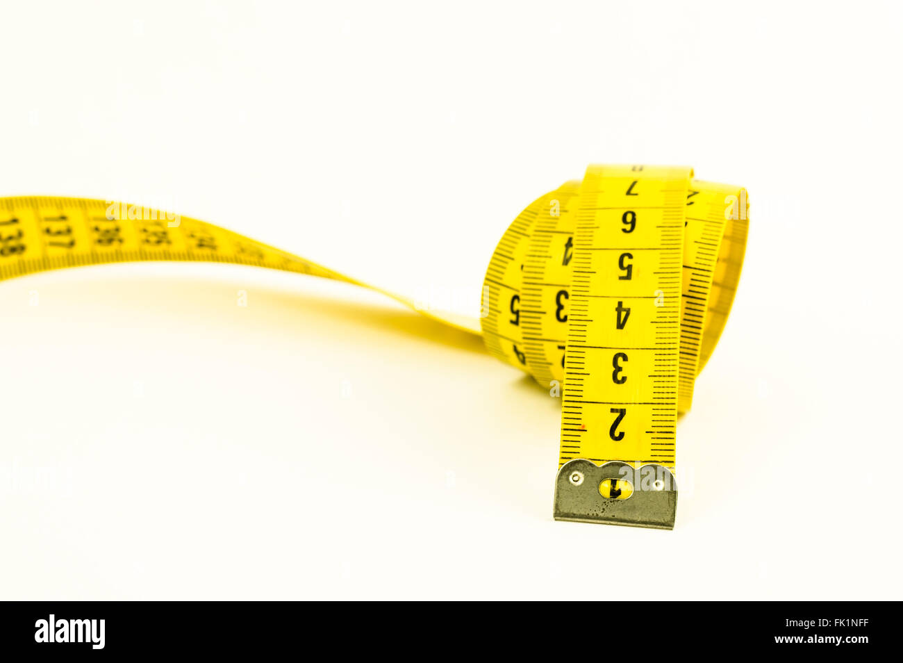 https://c8.alamy.com/comp/FK1NFF/still-life-with-a-yellow-tape-measure-and-a-pencil-over-white-FK1NFF.jpg