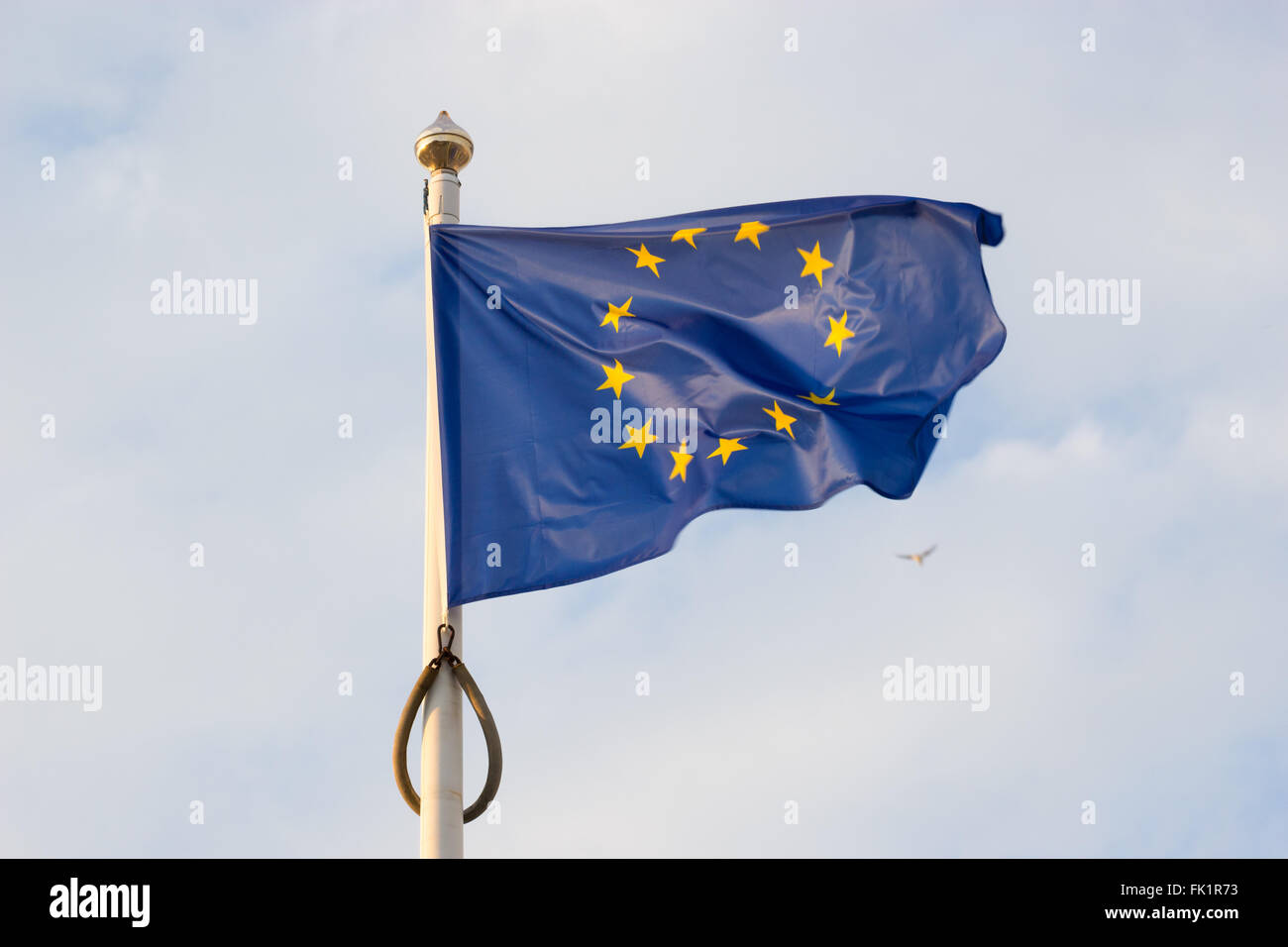 European union flag waving on blue sky background Stock Photo - Alamy