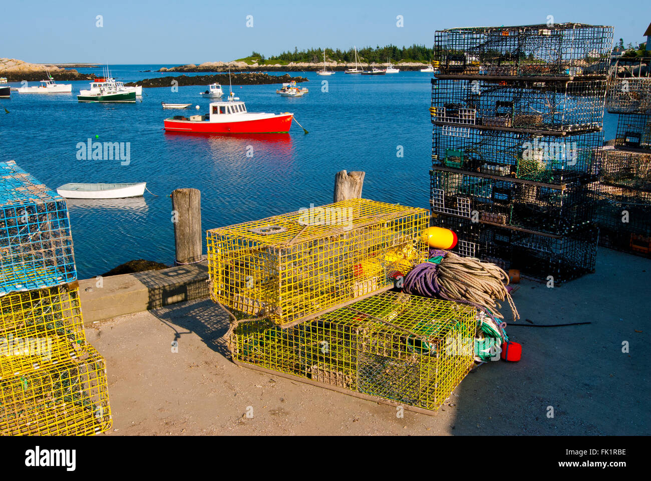 Colorful lobster traps are laid out on the dock for lobster boats