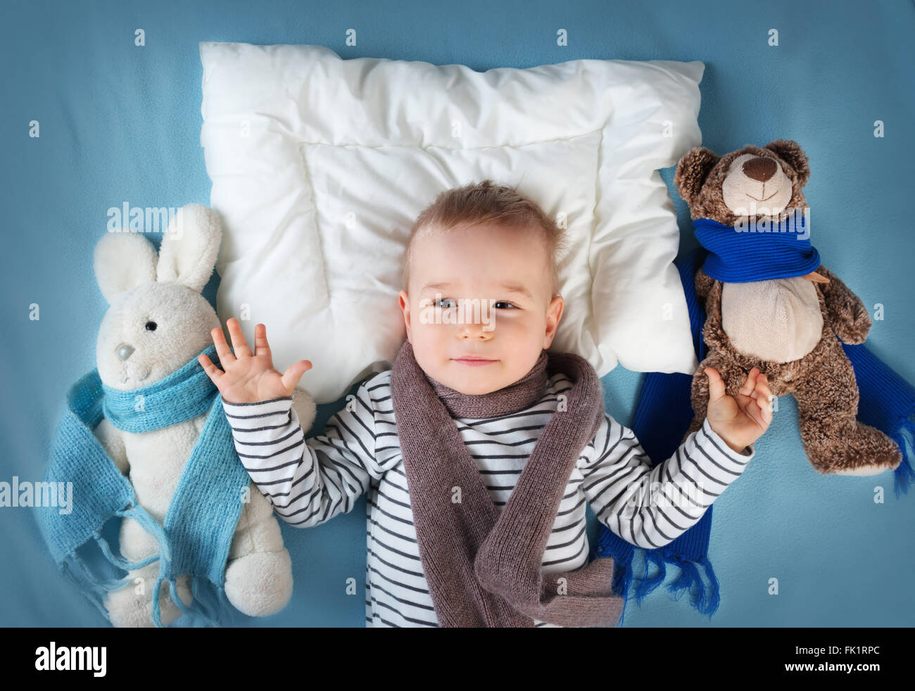 Ill boy lying in bed Stock Photo