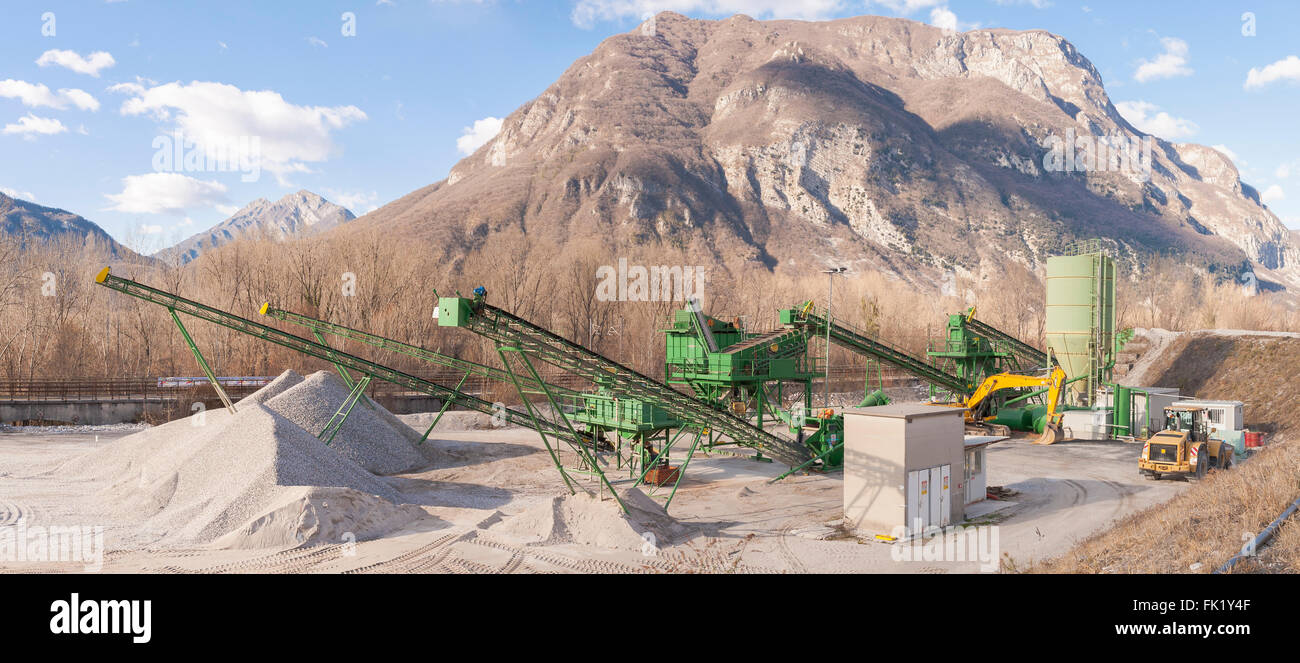 Gravel extraction plant.   Machinery and classification according gravel size distribution via conveyor belts. Stock Photo