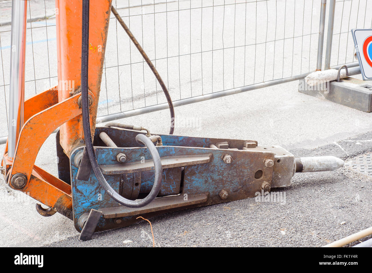 Large pneumatic hammer mounted on the hydraulic arm of a construction equipment Stock Photo