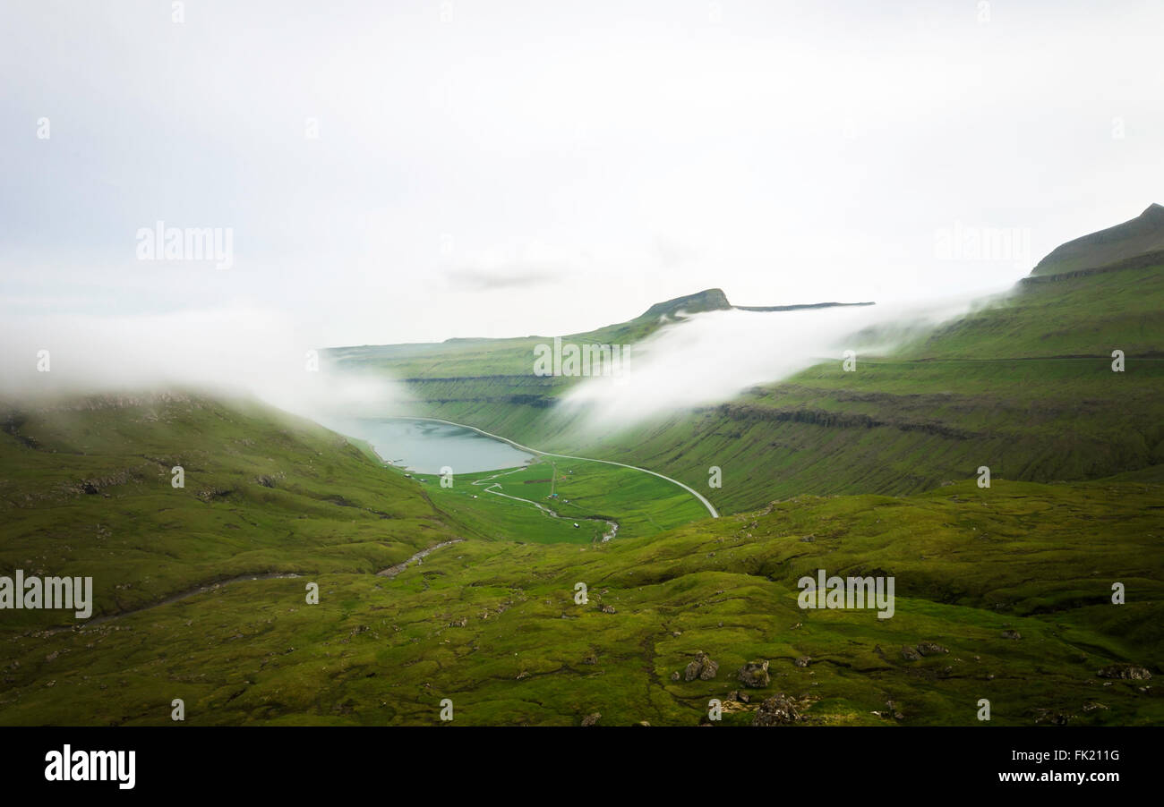 Fog lying on mountains. Faroe islands, Denmark, Europe. Long Exposure Stock Photo