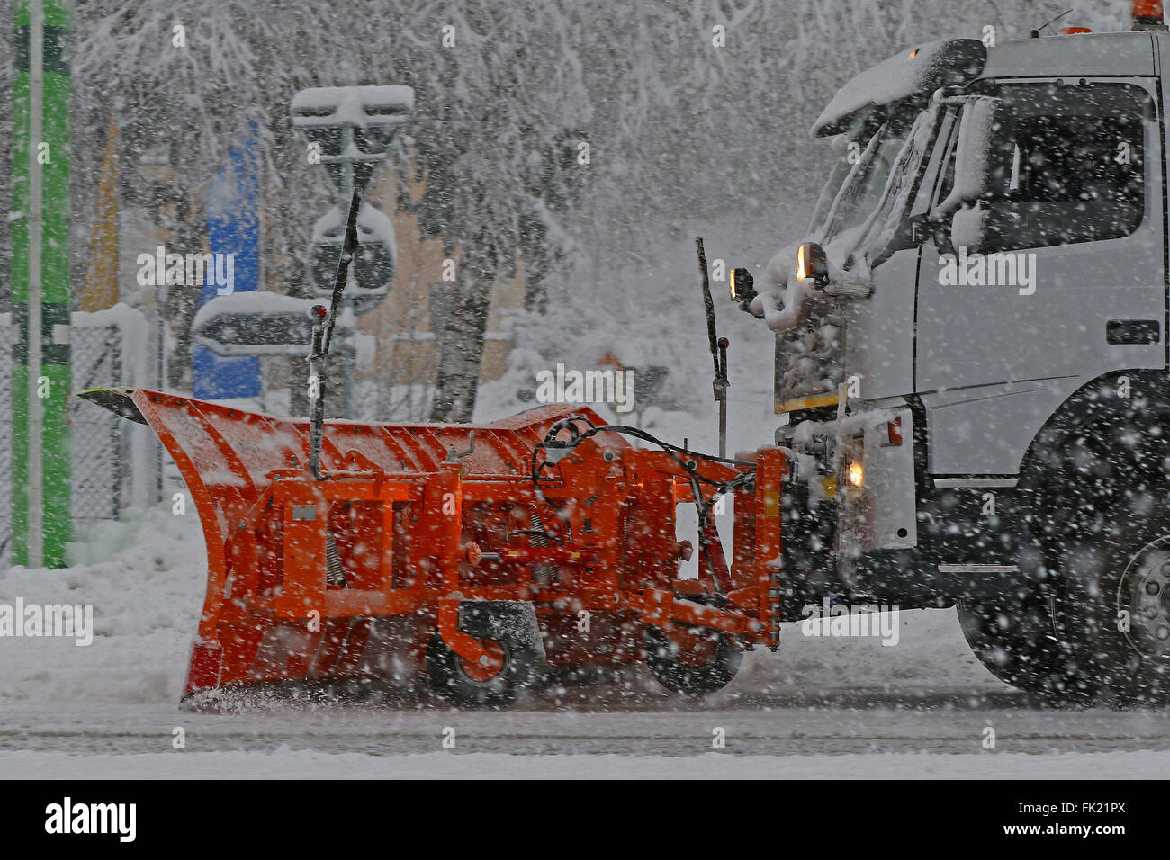 Detail of snow plow truck and blade in action during a heavy snow storm