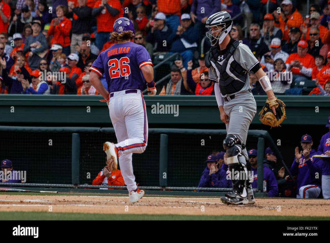 Greenville, SC, USA. 5th Mar, 2016. Reed Rohlman (26) of the Clemson Tigers gets walked home in the NCAA Baseball match-up between the Clemson Tigers and the South Carolina Gamecocks at Fluor Field in Greenville, SC. Scott Kinser/CSM/Alamy Live News Stock Photo