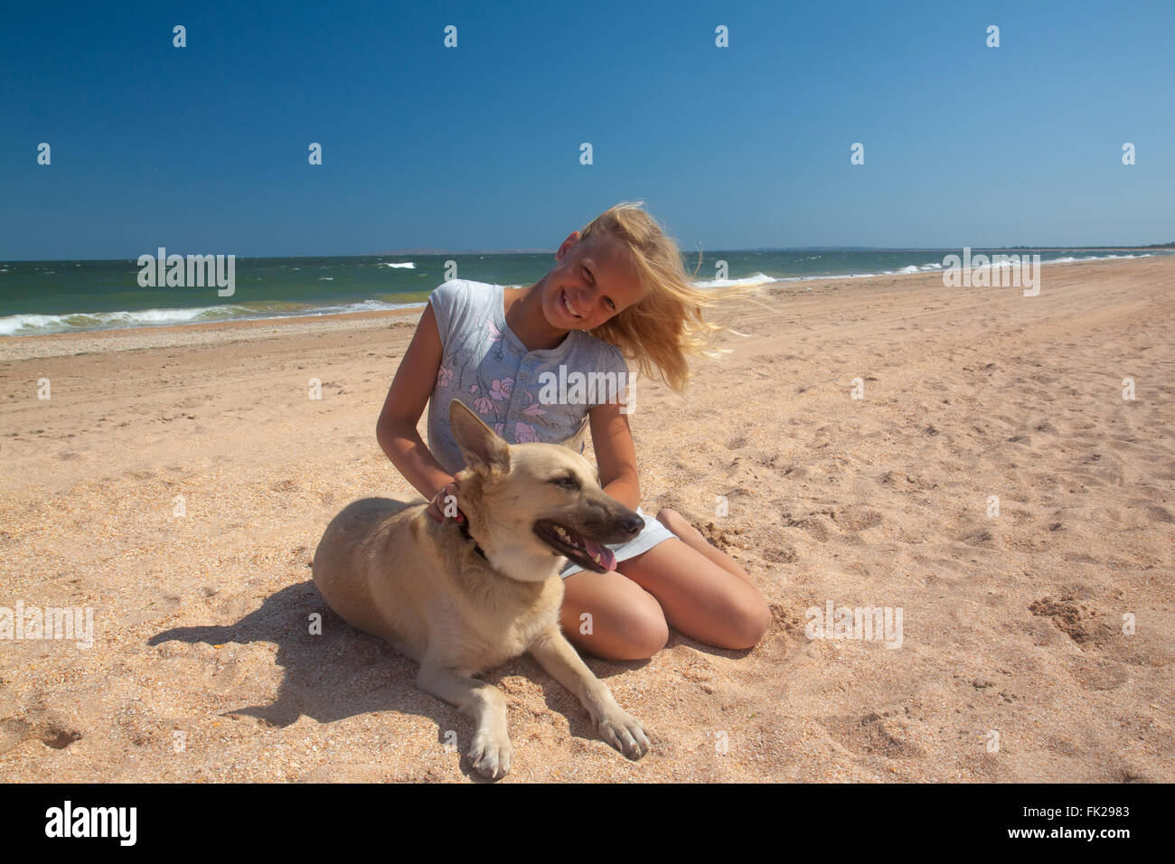 friendship concept girl with dog lying outdoors Stock Photo