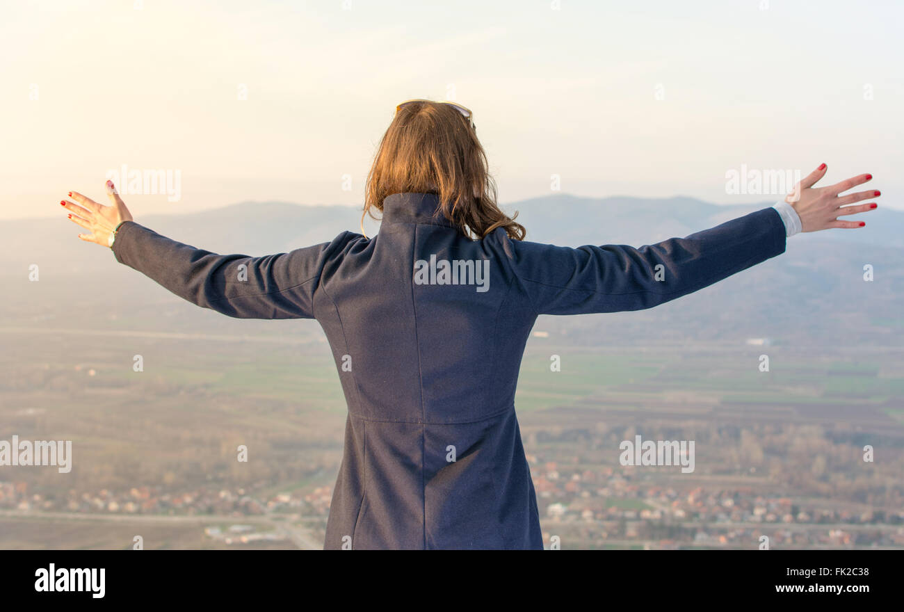 Girl on hiking trip enjoying the view from above Stock Photo