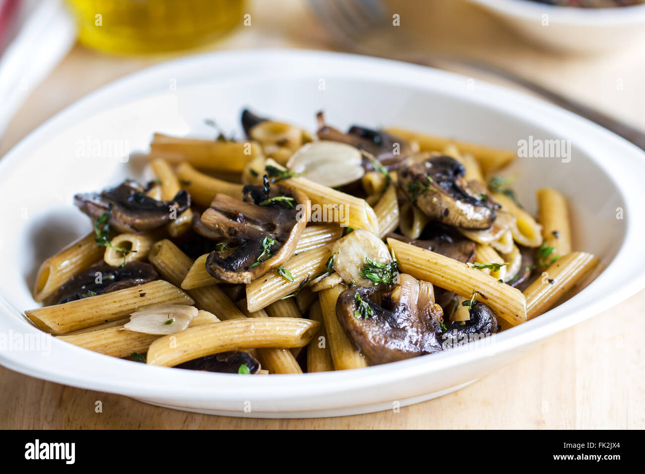 Penne with button mushroom and herb sauce Stock Photo