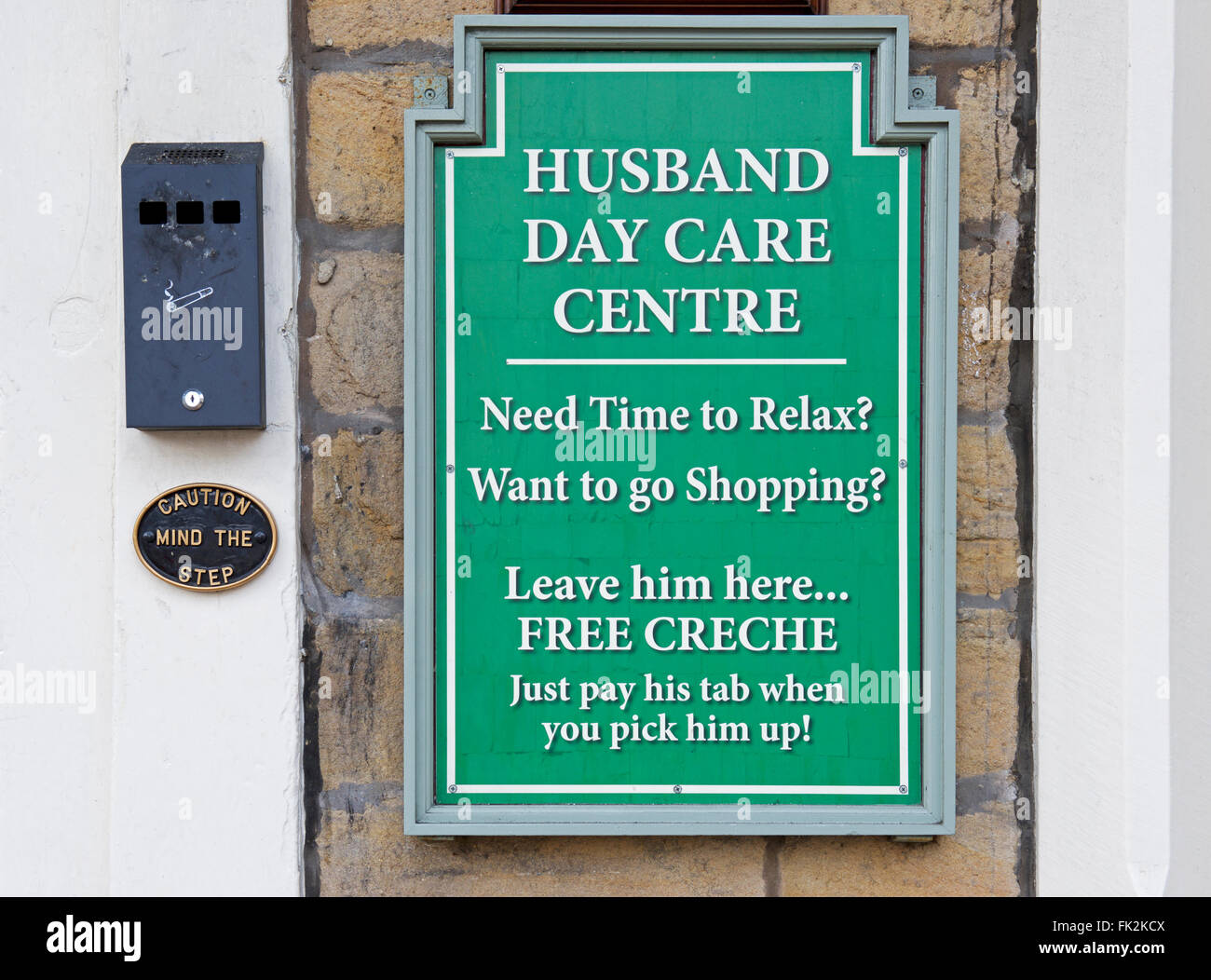 Sign on pub - day care for husbands - England UK Stock Photo