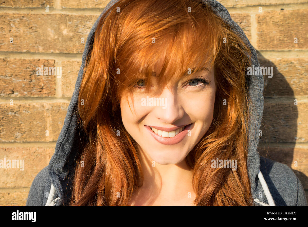 Head shot of a beautiful young female model with red hair and blue eyes Stock Photo