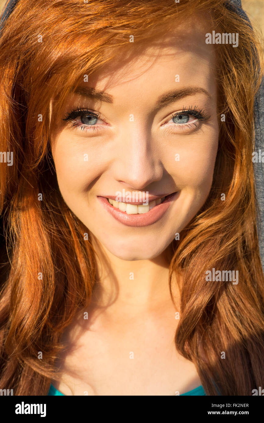 Head shot of a beautiful young female model with red hair and blue eyes Stock Photo