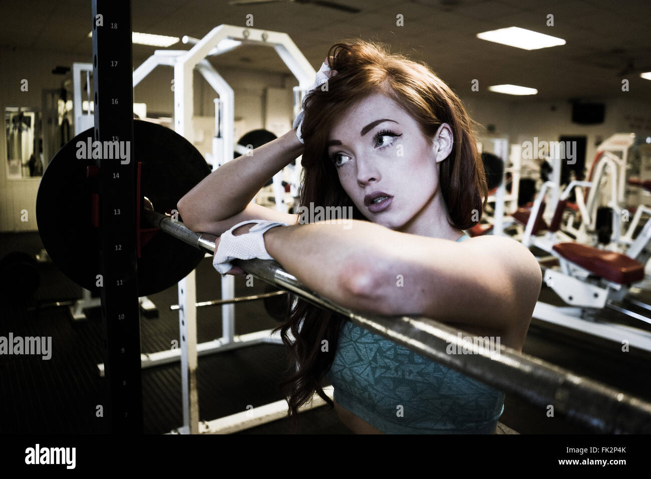 Female fitness model posing on a squats rack Stock Photo