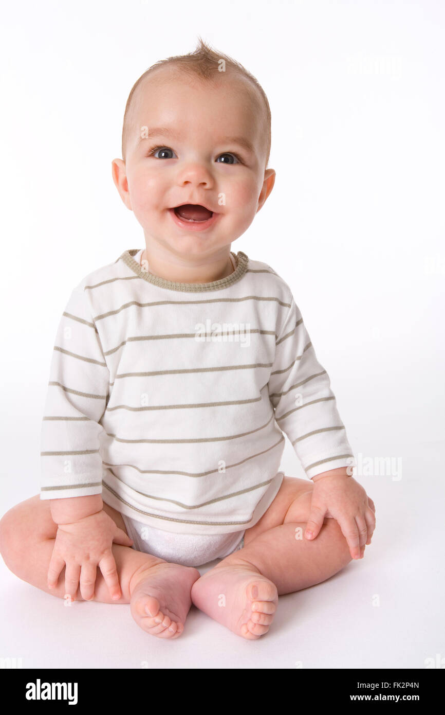 Happy Baby Boy Is Sitting On The Floor on white background Stock Photo Alamy