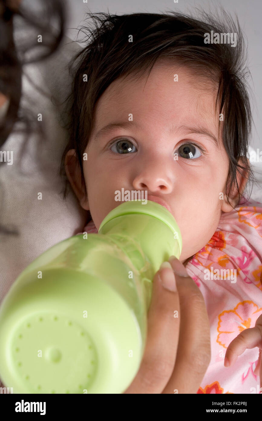 Baby Girl Is Drinking From A Babybottle Stock Photo Alamy
