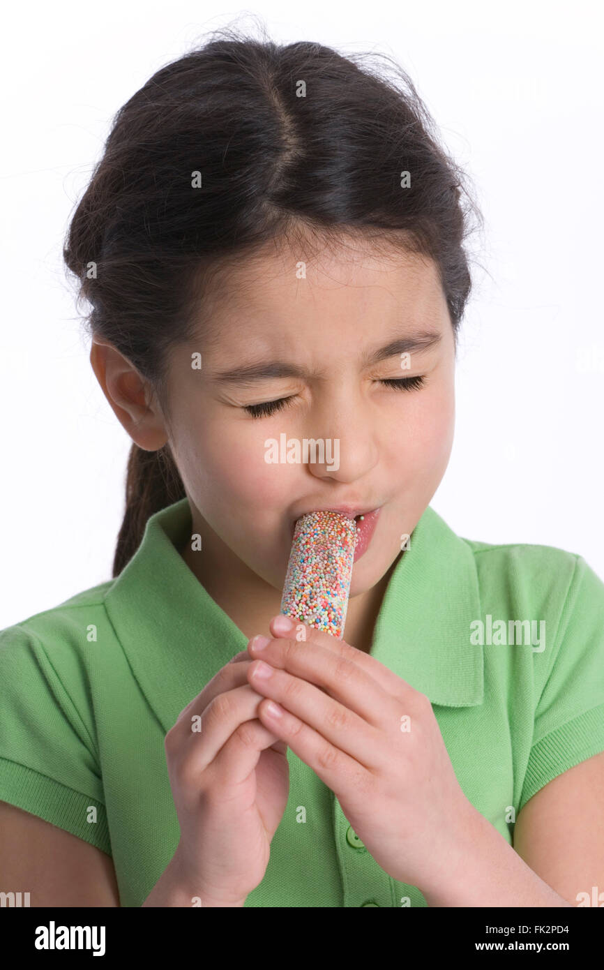 Little Girl Is Eating Icecream on white background Stock Photo