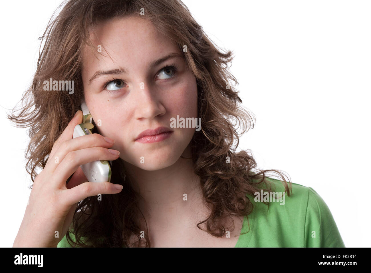 Teenage girl with a mobile phone on white background Stock Photo