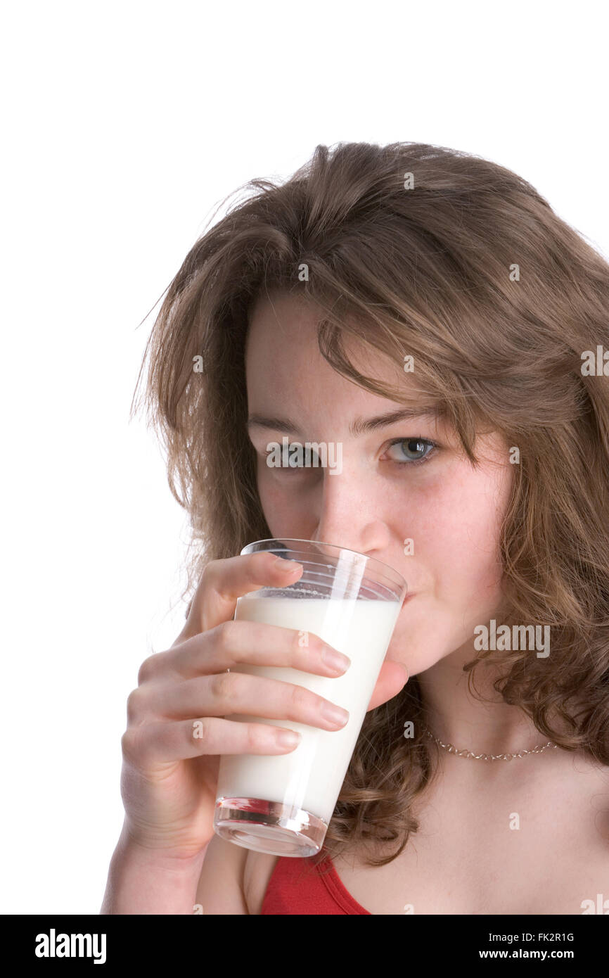 Teenage Girl Drinking A Glass Of Milk on white background Stock Photo
