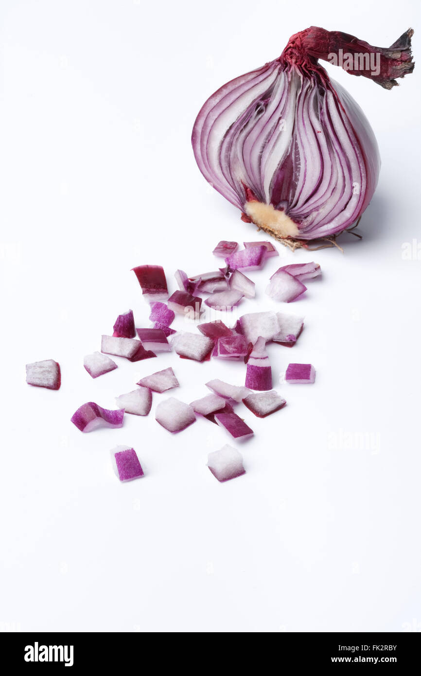 Half red onion with chopped pieces on white background Stock Photo