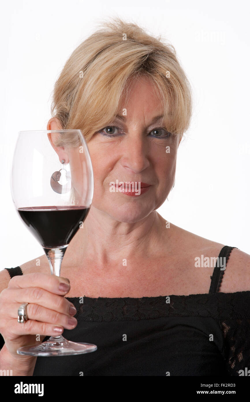 Charming Senior Woman Holding A Glass Of Red Wine on white background ...