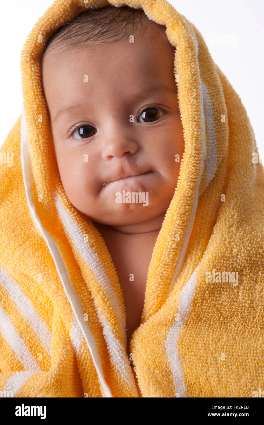 Baby Girl Wrapped In A Towel With An Odd Expression on white background Stock Photo