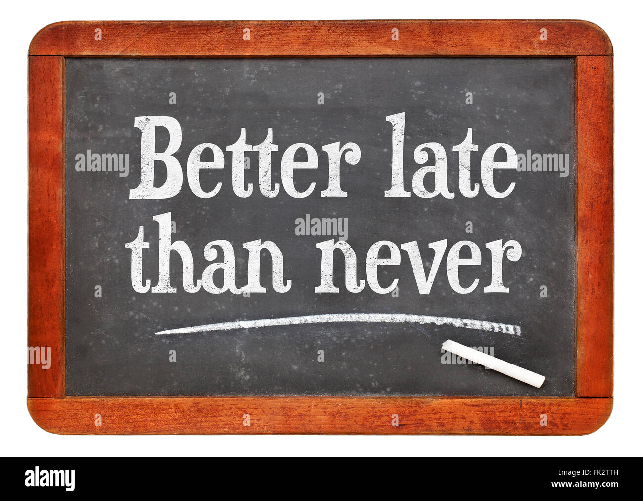 Better late than never proverb - white chalk text on a vintage slate blackboard Stock Photo